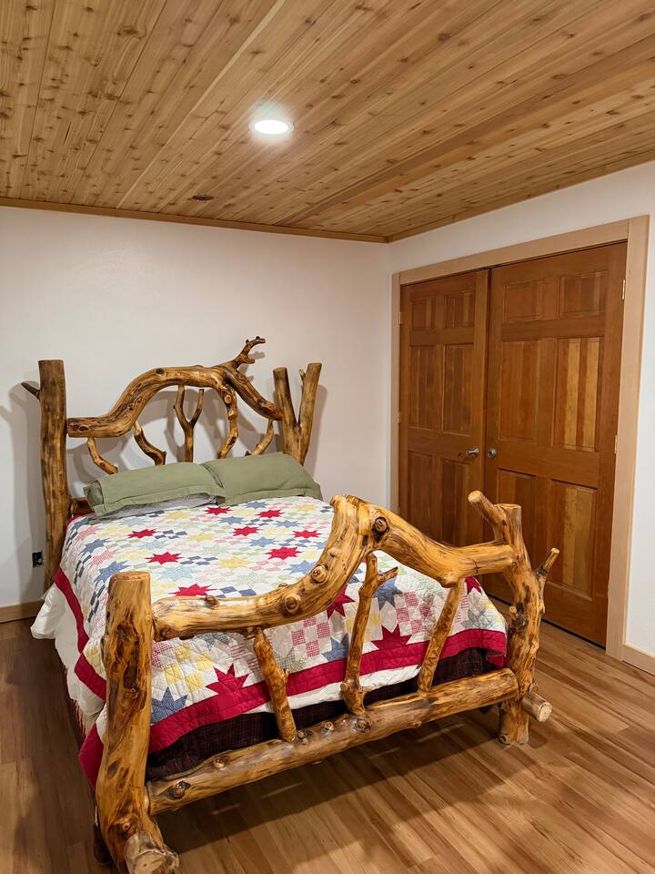 Bedroom with hand-carved log bed frame
