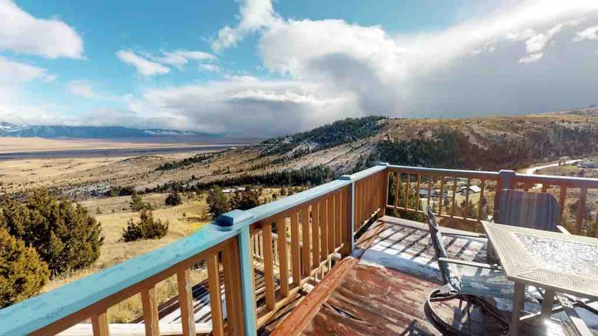 Panoramic Madison Valley view from the wrap-around deck — snow-capped peaks and wide sky