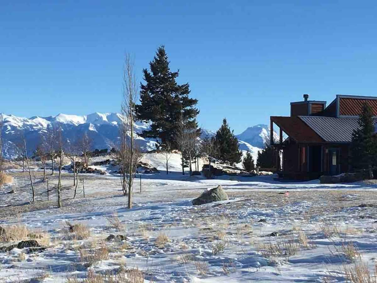 The property in winter with snow-capped mountains
